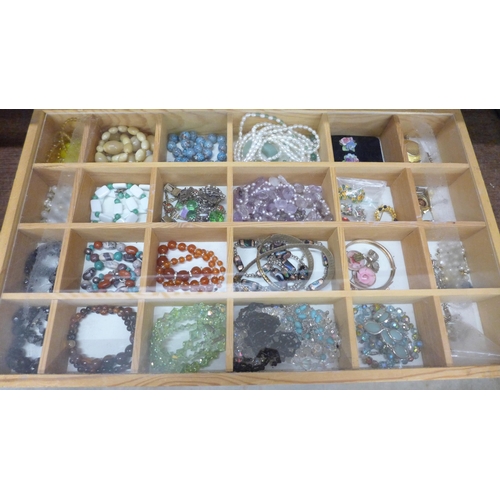 693 - A display case of costume jewellery