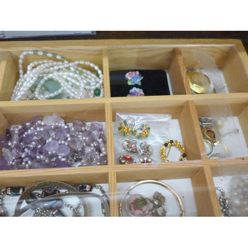 693 - A display case of costume jewellery