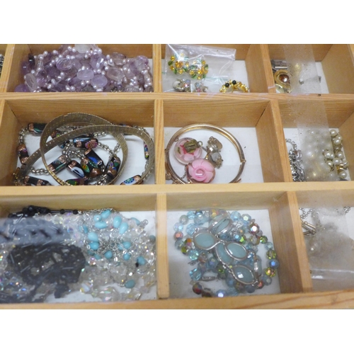 693 - A display case of costume jewellery