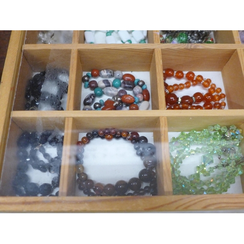 693 - A display case of costume jewellery