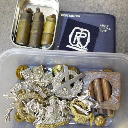 720 - A suitcase containing military items from WWI onwards, assorted cap badges including Glasgow Highlan... 