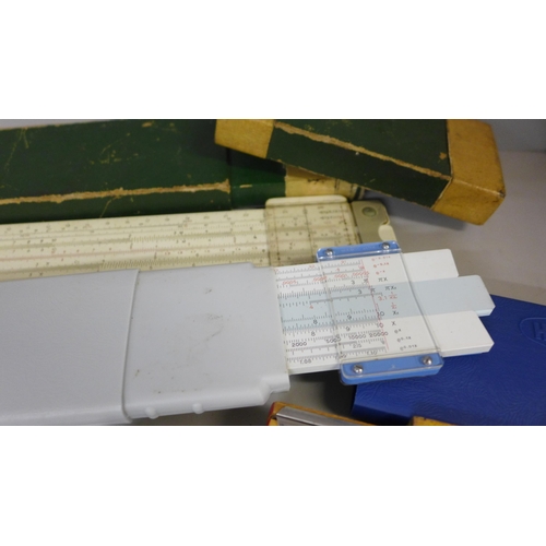 734 - A Lee Guinness technical drawing set, slide rules and rulers, etc.