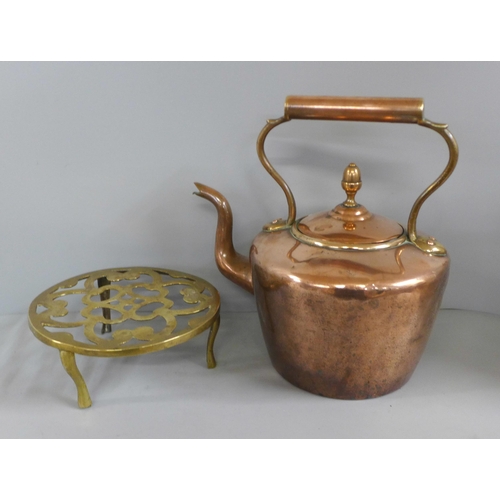 772 - A Victorian copper kettle and a brass trivet