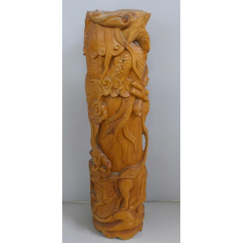 775 - An oriental wooden carving with bone inset eyes, 39.5cm