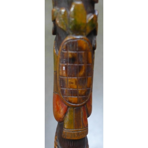 783 - A carved wooden walking stick, tropical hardwood, decorated with snakes, lizards, birds and mythical... 