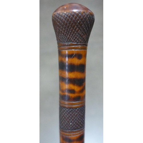 783 - A carved wooden walking stick, tropical hardwood, decorated with snakes, lizards, birds and mythical... 