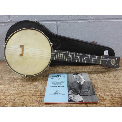 784 - A cased banjo, marked Keech, with four George Formby EPs