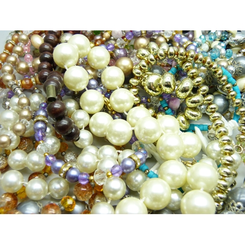 802 - A collection of thirty Czech and other retro bead necklaces, old shop stock