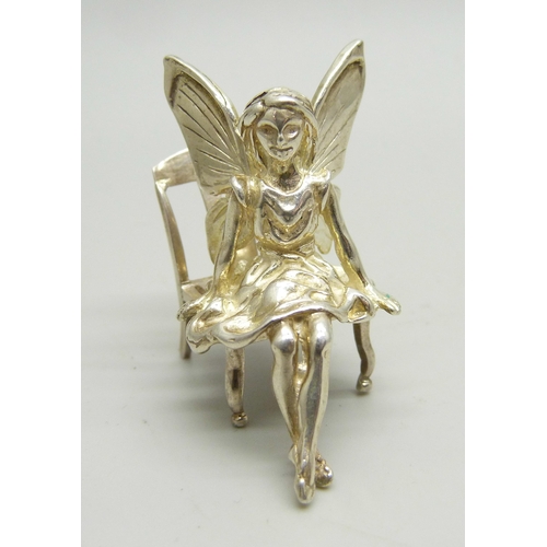 803 - A miniature silver fairy with chair, 3.6cm tall, 17g