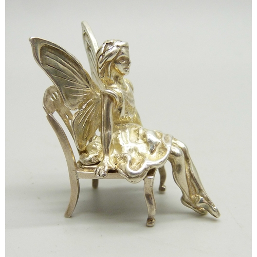 803 - A miniature silver fairy with chair, 3.6cm tall, 17g