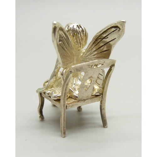 803 - A miniature silver fairy with chair, 3.6cm tall, 17g