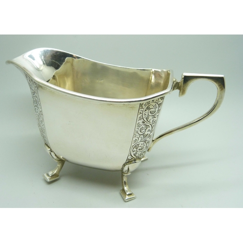 805 - A silver milk jug with bright cut engraving, Birmingham hallmark, 189g