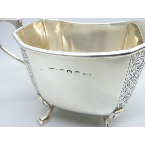 805 - A silver milk jug with bright cut engraving, Birmingham hallmark, 189g