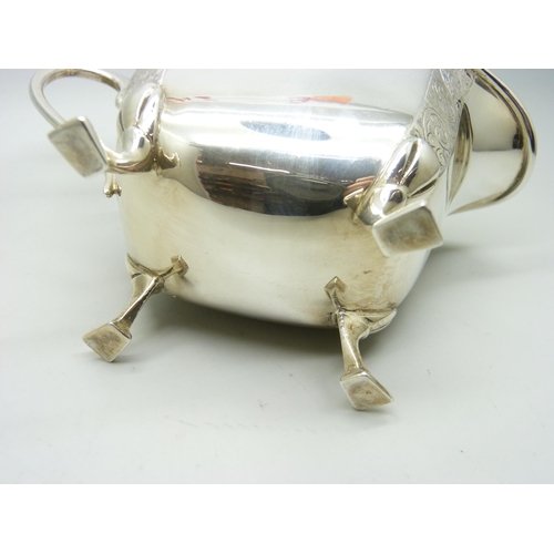 805 - A silver milk jug with bright cut engraving, Birmingham hallmark, 189g