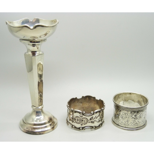 812 - A silver posy vase, 12.5cm and two silver napkin rings, (vase with weighted base), total weight incl... 