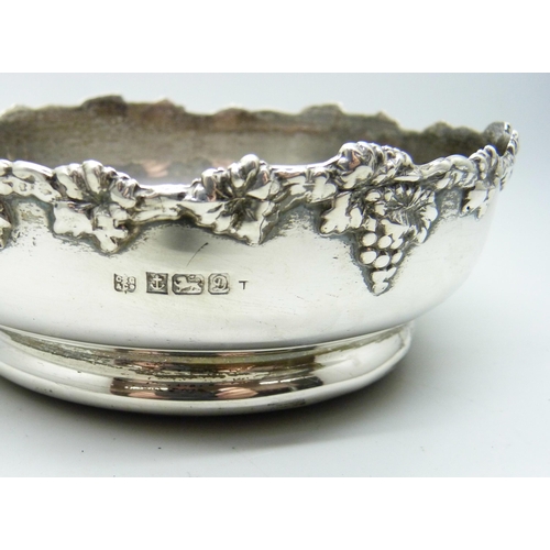 819 - A silver wine coaster with grape and vine decoration, Birmingham 1978