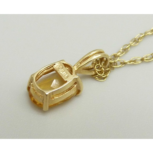 865 - A 14ct gold pendant set with a citrine on a fine 9k gold chain, chain approximately 47cm, pendant 1.... 