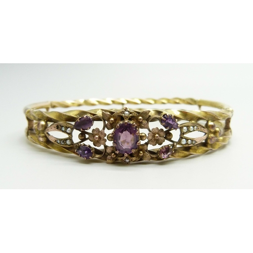 871 - A yellow metal bangle set with purple stones and seed pearls, a/f (one pearl missing, one stone repl... 