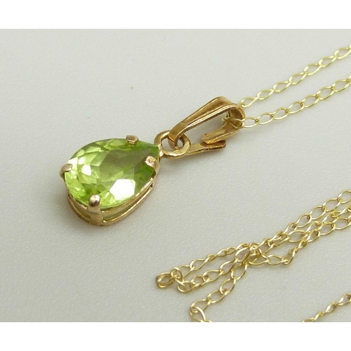 875 - A 10k gold and peridot pendant on a fine 10k gold chain, 0.8g, chain approximately 46cm, pendant 1.4... 