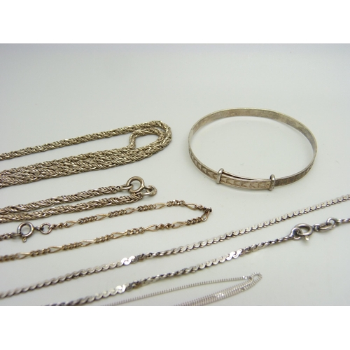 876 - A collection of silver jewellery - a 24cm figaro bracelet, a child's bangle, a pendant and chain and... 