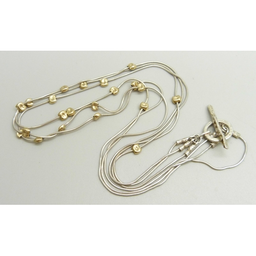 881 - A silver three strand snake chain necklace with gold tone beads and Brutalist style clasp, hallmarke... 