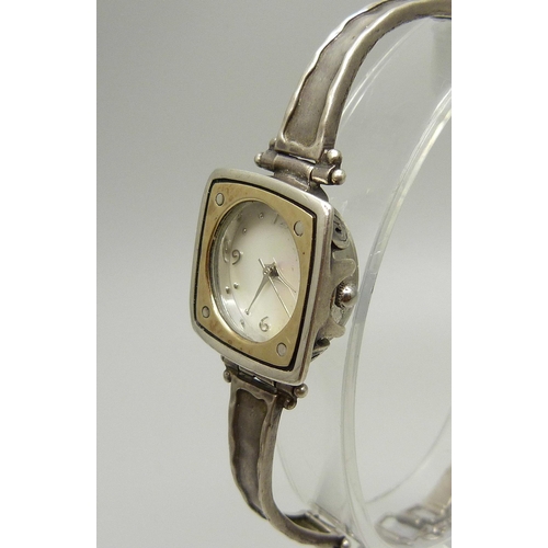 885 - A lady's silver wristwatch with hammered design bezel and strap, hallmarked on the clasp with plaque... 