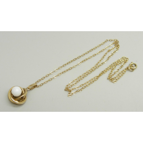 889 - A yellow metal and bead pendant on a fine 9ct gold chain, 44cm, 1.6g