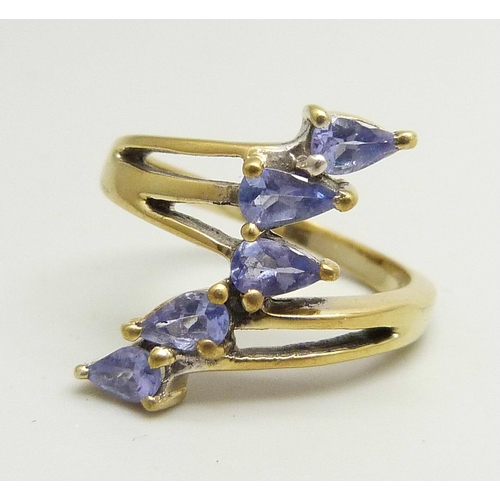 893 - A silver gilt, five stone tanzanite bypass ring, N