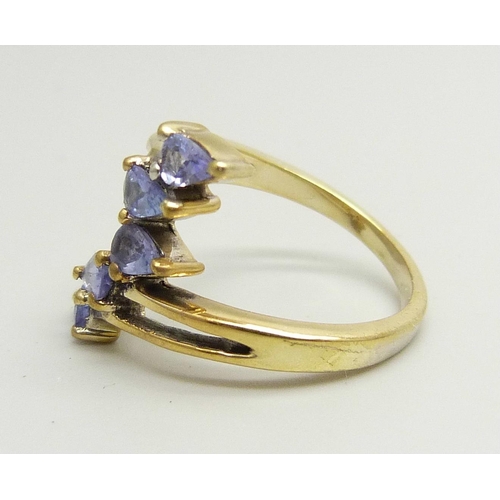 893 - A silver gilt, five stone tanzanite bypass ring, N