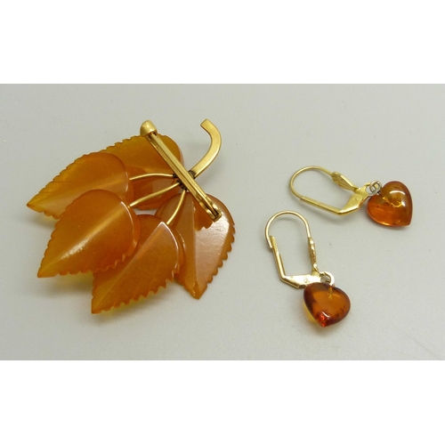 903 - An amber coloured brooch in the form of a leaf and a pair of Baltic amber earrings