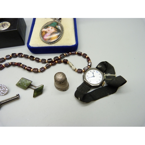 922 - A garnet necklace, a pair of silver cufflinks, a silver cased wristwatch, a silver fox bar brooch, e... 