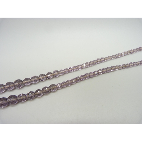 923 - A faceted amethyst bead necklace, the bale marked 9ct, with a base metal clasp, 4.6cm pendant includ... 