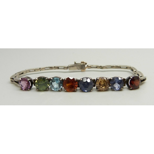 924 - A white metal bracelet set with eight multi-coloured stones, 8g, 16.5cm long