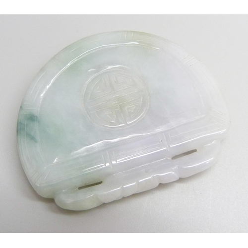 A carved jade pendant, 5.6cm x 4.6cm, 41g