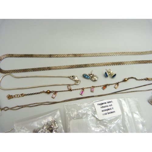 938 - A collection of silver jewellery including a necklace set with red diamonds, earrings, a gilt bracel... 