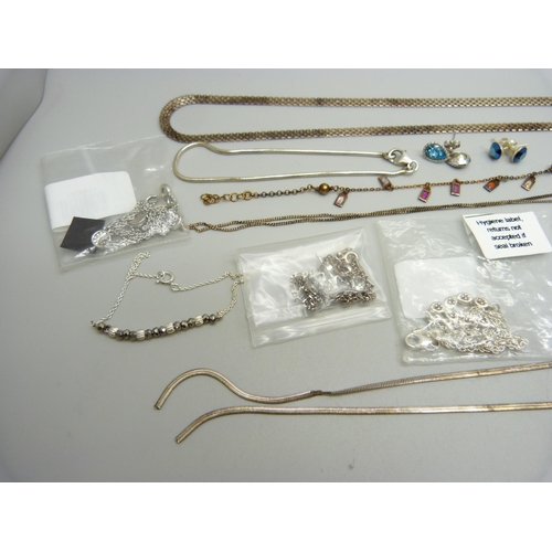 938 - A collection of silver jewellery including a necklace set with red diamonds, earrings, a gilt bracel... 