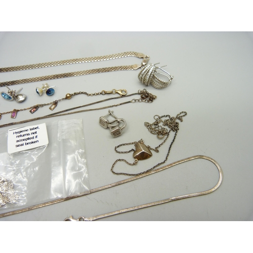 938 - A collection of silver jewellery including a necklace set with red diamonds, earrings, a gilt bracel... 