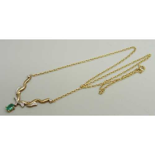 943 - A 9ct gold necklace set with diamonds and an emerald, 45cm, 3.5g