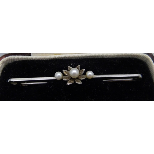 949 - A 9ct white gold bar brooch set with three cultured pearls, 5cm, cased, 1.6g