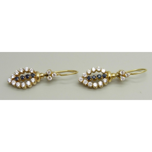 957 - A pair of yellow metal drop earrings set with white and dark blue stones, approximately 3.6cm drop i... 