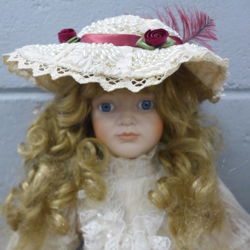 991 - A bisque head doll with wind up musical mechanism