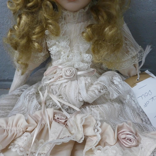 991 - A bisque head doll with wind up musical mechanism