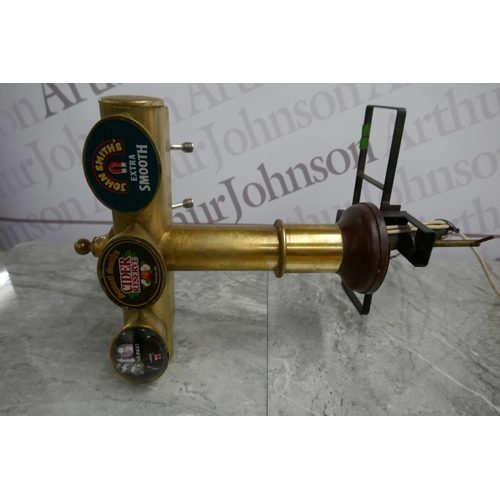 2380 - A brass beer pump with 3 taps and 2 bar mats