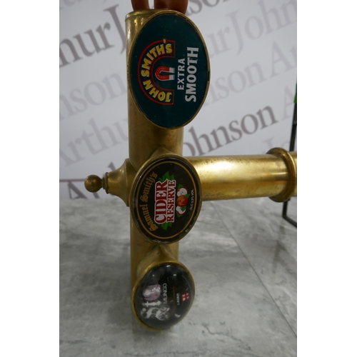 2380 - A brass beer pump with 3 taps and 2 bar mats