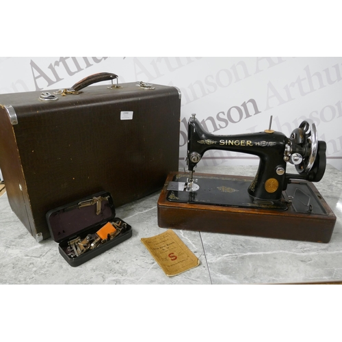 2390 - A vintage Singer EC182136 sewing machine with hard case, instructions and a box of sewing machine ac... 