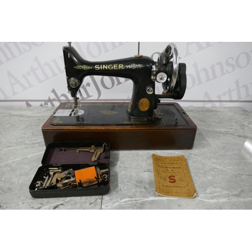 2390 - A vintage Singer EC182136 sewing machine with hard case, instructions and a box of sewing machine ac... 