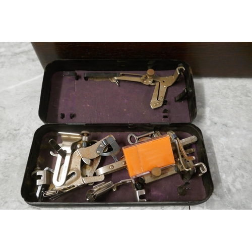 2390 - A vintage Singer EC182136 sewing machine with hard case, instructions and a box of sewing machine ac... 