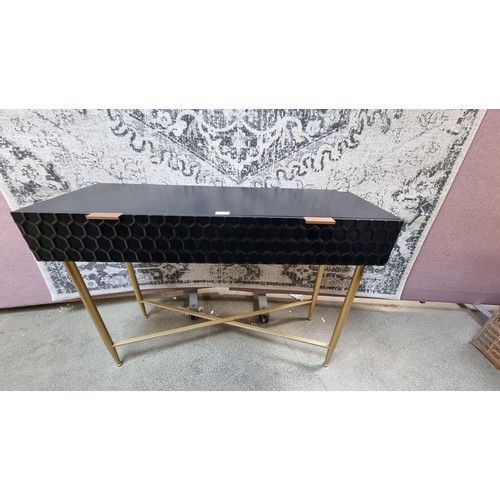 1568 - A black console table with gold legs