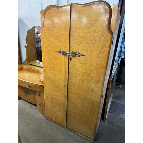 308 - An Art Deco birds eye maple bedroom suite, comprising; two wardrobes and a dressing table