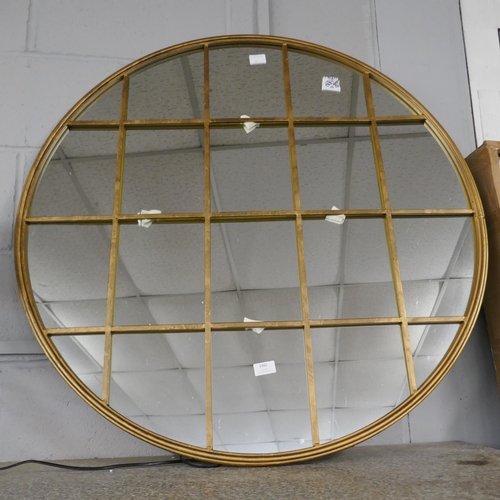 1442 - A gold circular mirror